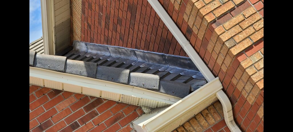 Lead wall flashing on a tile roof